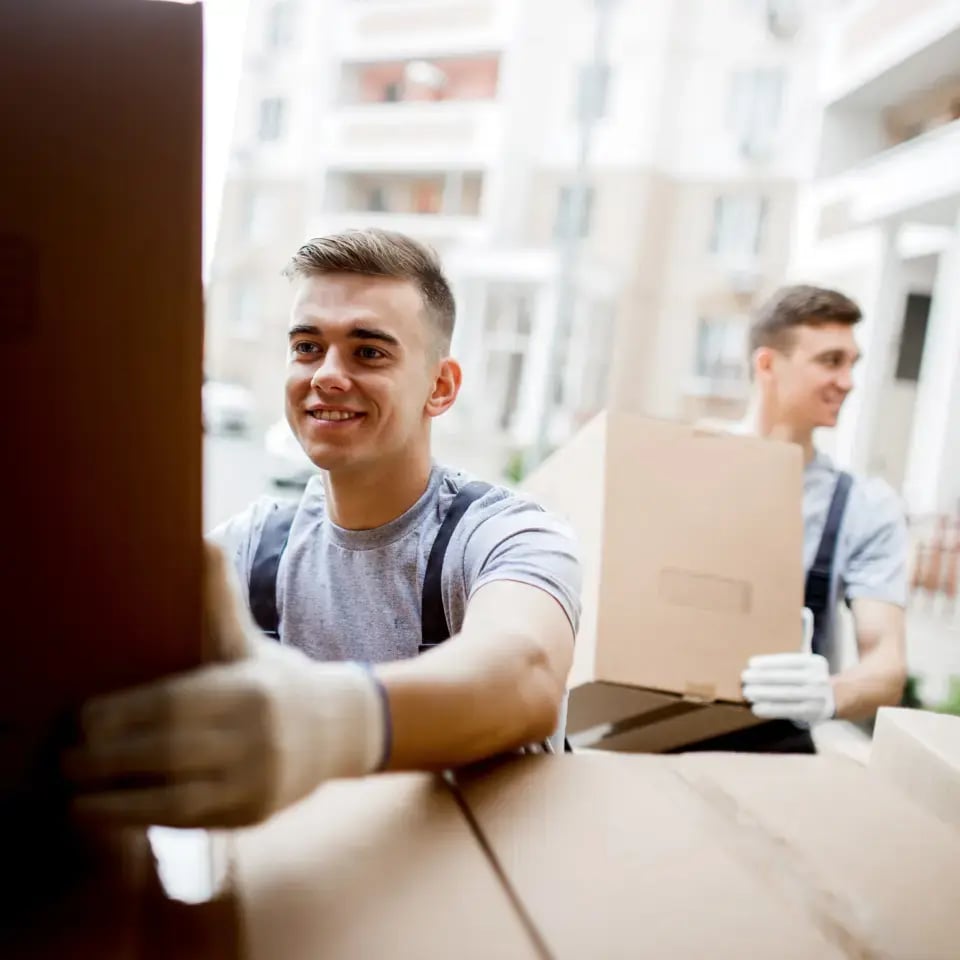 two delivery drivers loading boxes