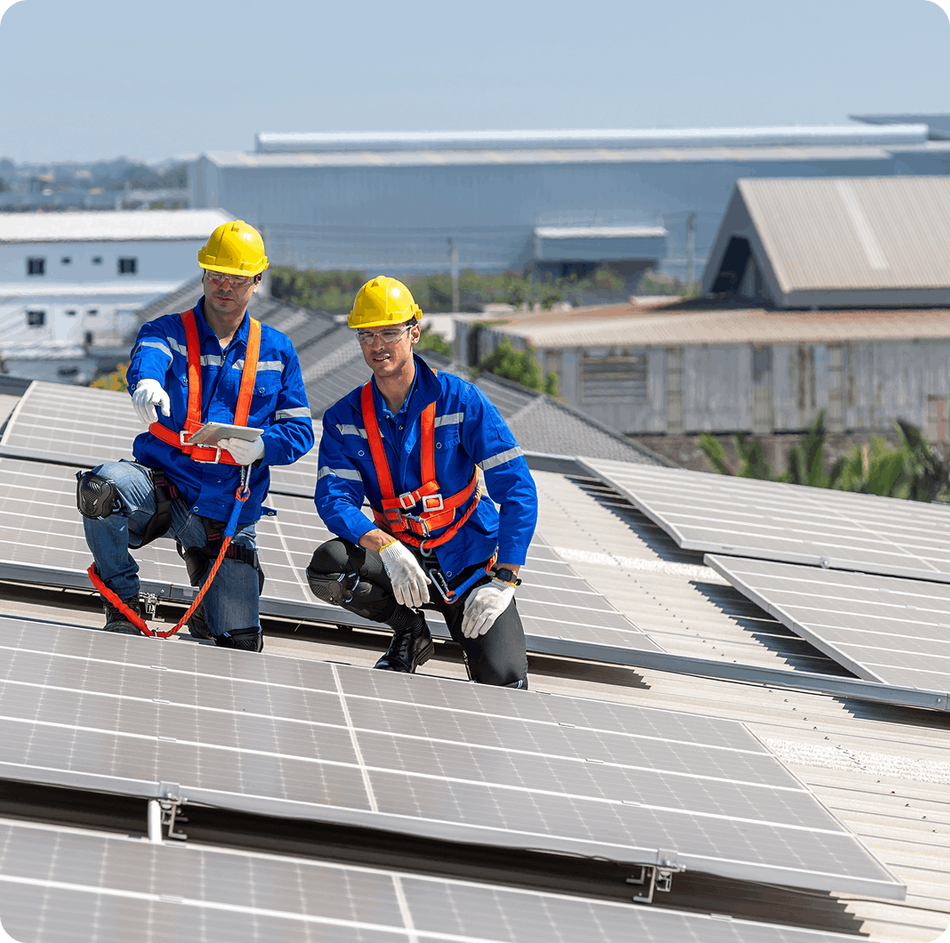 Two technicians installing solar panels